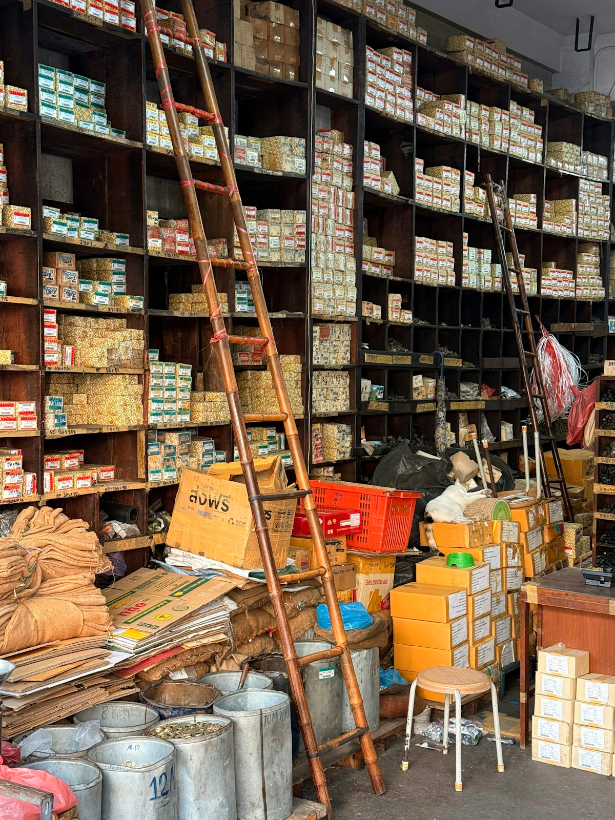 A cluttered hardware store with shelves full of boxes